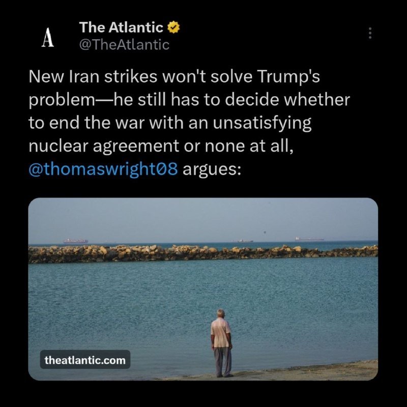 A screenshot of a post from The Atlantic's verified X account featuring a photo of a man standing on a shore facing the sea.