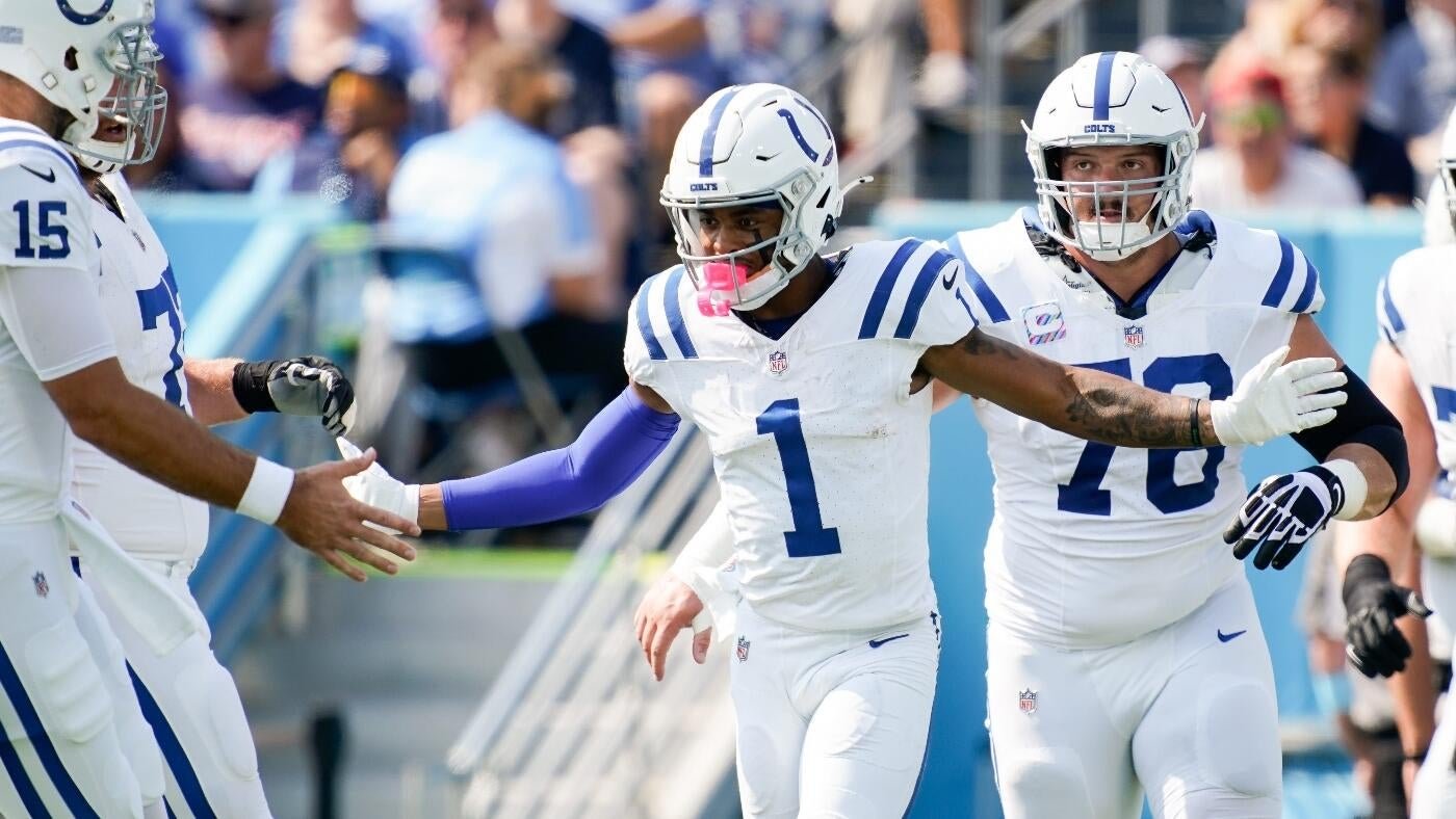 Indianapolis Colts players in white and blue uniforms, including #1 and #78, celebrate together on the field during a football game.