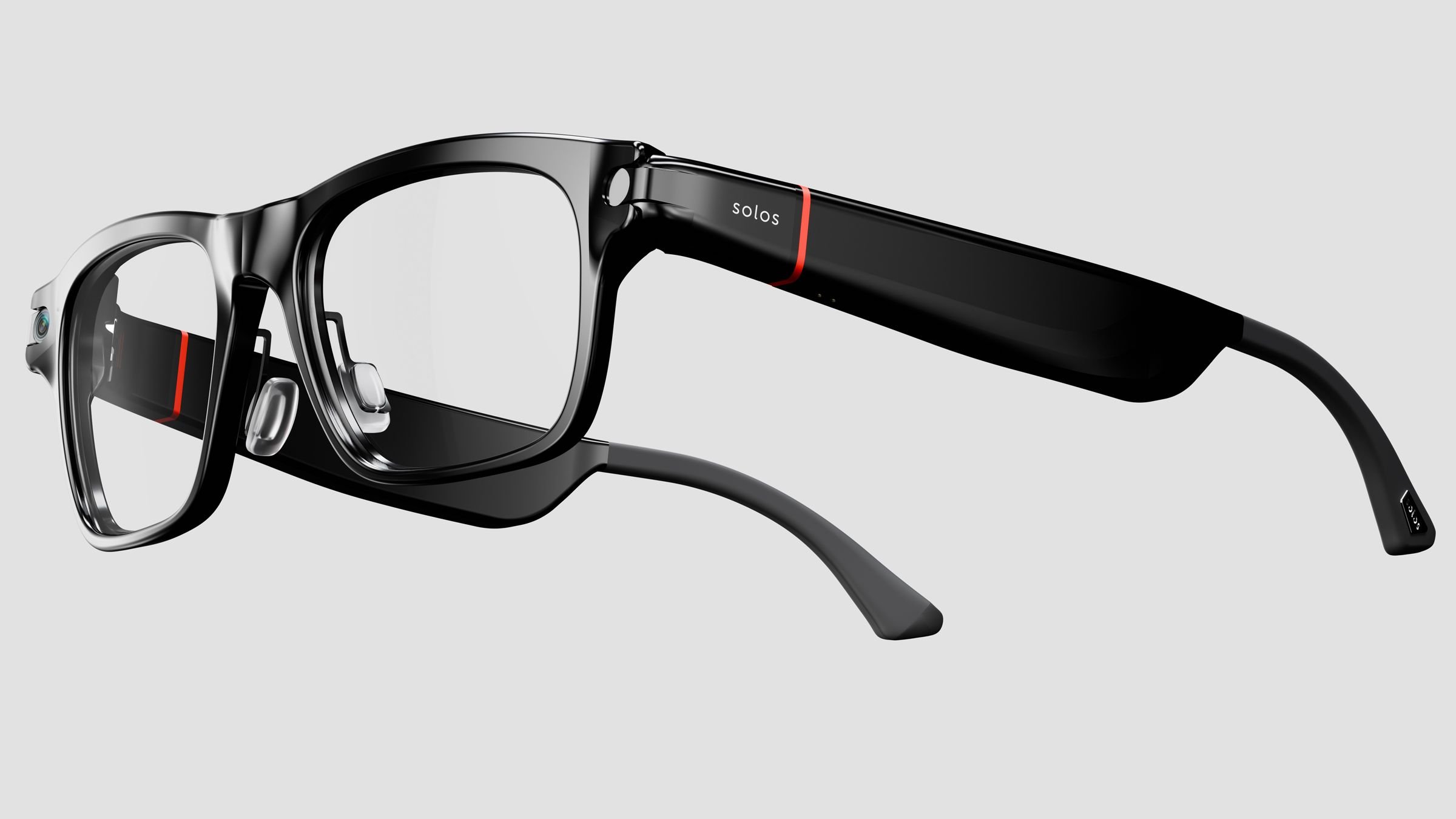 A product photograph shows black smart glasses branded "solos" with clear lenses, red accent lines on the temples, and a visible camera lens on the front frame.