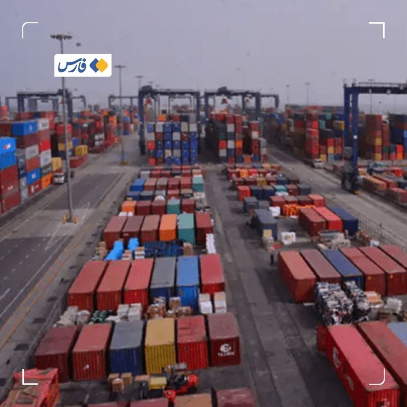 An aerial view shows rows of multicolored shipping containers stacked at a large port terminal, with gantry cranes visible in the background.