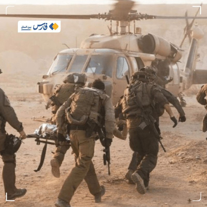 Armored soldiers carrying rifles and backpacks run toward a large military helicopter in a dusty desert setting.