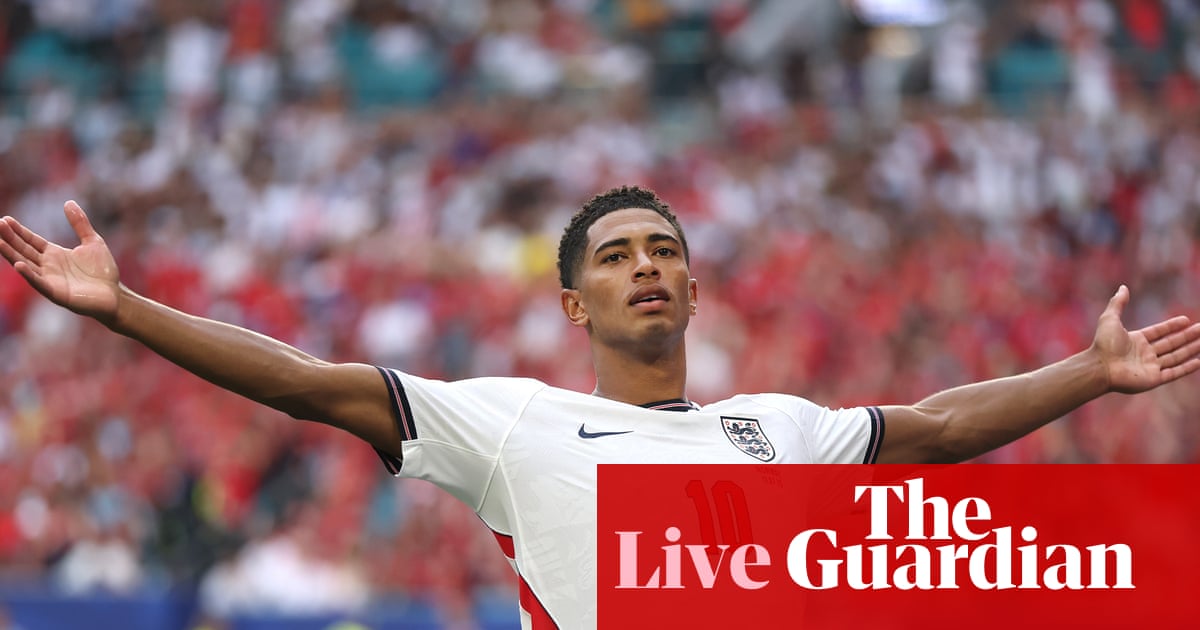 Two soccer players in dark blue jerseys embrace, with the FIFA World Cup 2026 logo displayed alongside text reading "355M USD GIVEN TO CLUBS GLOBALLY."