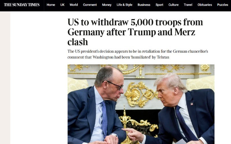 A news webpage from The Sunday Times displays the headline "US to withdraw 5,000 troops from Germany after Trump and Merz clash," above a photo of two suited men seated facing each other.