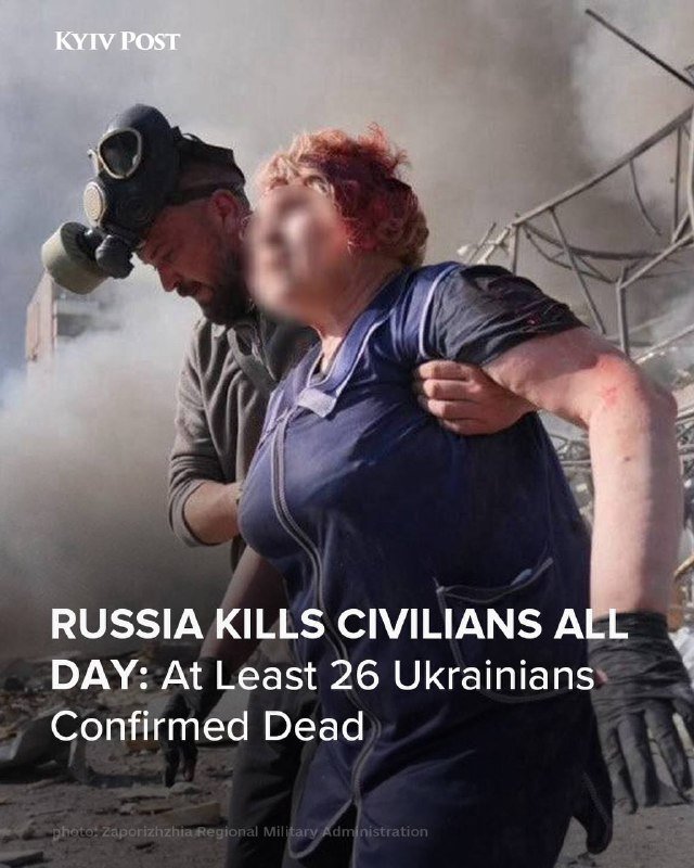 A bloodied woman is carried by a man wearing a gas mask amid smoke and debris, with overlaid text reading "RUSSIA KILLS CIVILIANS ALL DAY: At Least 26 Ukrainians Confirmed Dead."