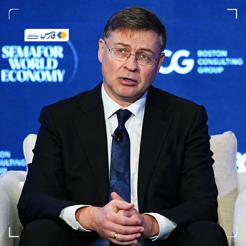 A bespectacled man in a dark suit and blue tie speaks while seated at a panel, backed by "Semafor World Economy" and "Boston Consulting Group" signage.
