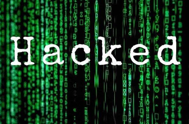 Digital graphic featuring the white word "Hacked" overlaid on a black background filled with falling green matrix-style code.
