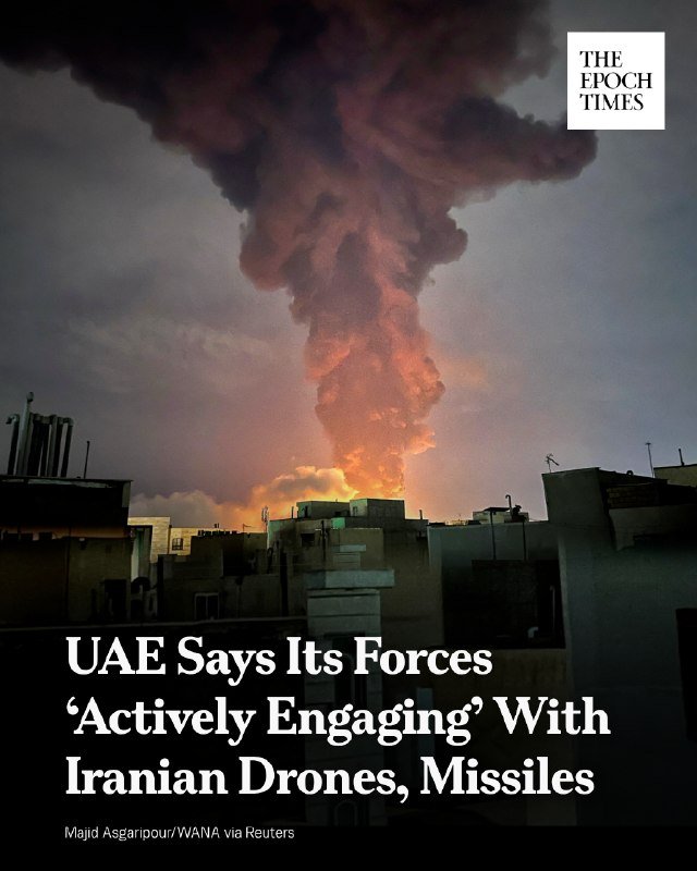 A large plume of dark smoke rises from a fire behind low-rise buildings, with "The Epoch Times" logo and a headline about the UAE.
