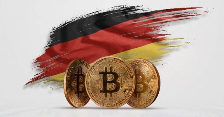 Three gold Bitcoin tokens are displayed in front of a black, red, and yellow brushstroke graphic resembling the German flag.