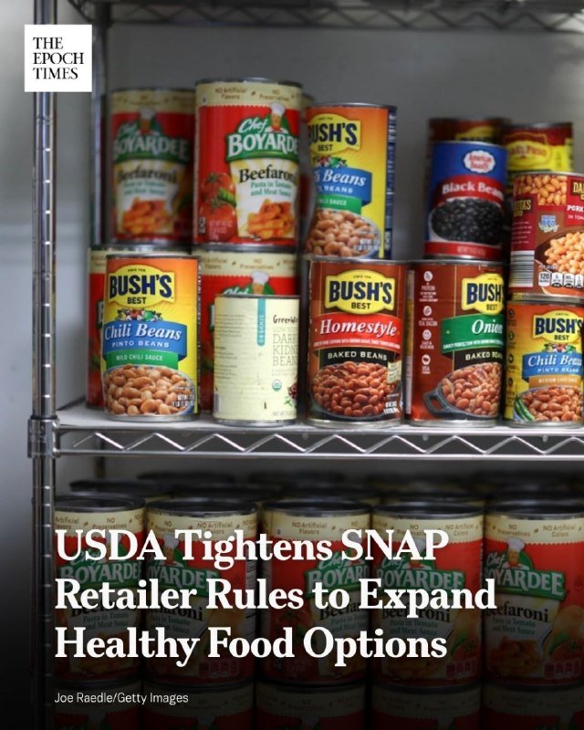 Canned beans and pasta products, including Bushs and Chef Boyardee brands, sit stacked on metal wire shelving in a pantry setting.