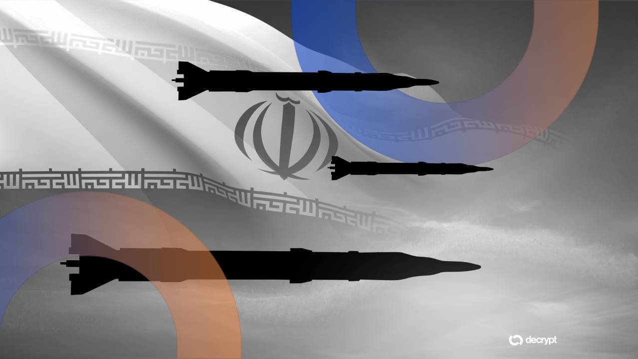 A graphic illustration depicts three black missile silhouettes overlaid on a faded Iranian flag with a cloudy sky background, bearing a "decrypt" watermark.