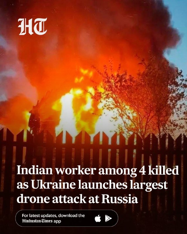 A Hindustan Times promotional graphic showing a large fire and thick smoke behind a wooden fence, with the headline "Indian worker among 4 killed as Ukraine launches largest drone attack at Russia."