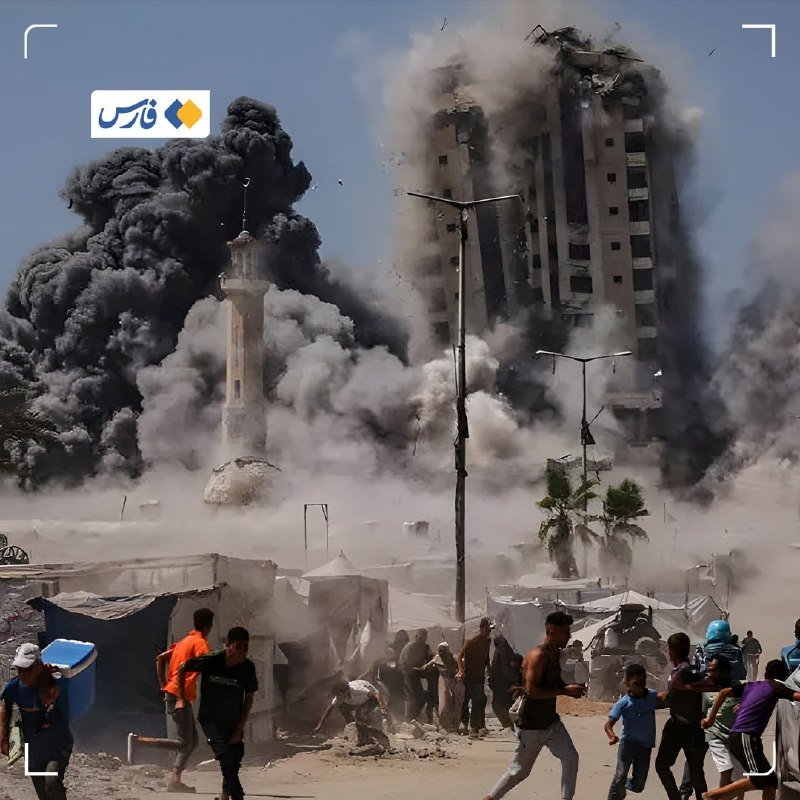 A large building collapses amid massive plumes of smoke and dust while people flee past tents in the foreground.