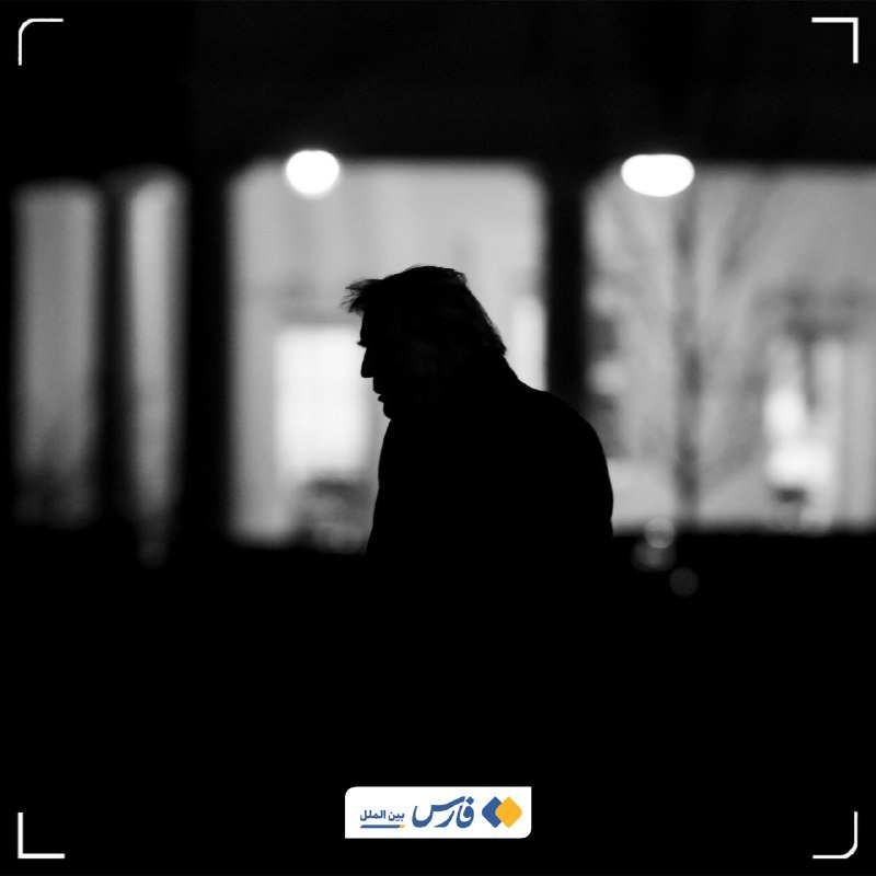 Silhouette of a person in profile against blurred background lights, with an Arabic logo at the bottom.