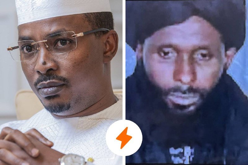Side-by-side portraits: a man in a white cap, glasses, and white shirt with clasped hands, alongside a grainy photo of a bearded man in dark clothing, separated by an orange lightning-bolt icon.