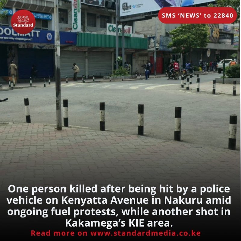 An empty street with closed shop shutters, a few pedestrians, and a motorcyclist, with overlaid text reporting a death and shooting during fuel protests.