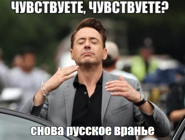 A man in a gray blazer and black shirt stands with eyes closed and hands raised, with Russian text reading "ЧУВСТВУЕТЕ, ЧУВСТВУЕТЕ?" above and "снова русское вранье" below.