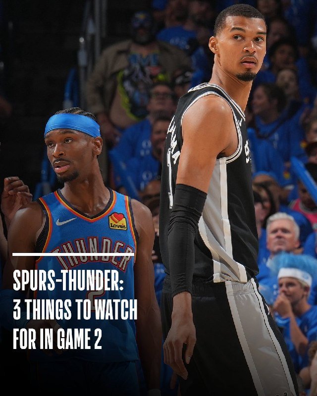 Two basketball players, one in a blue Thunder jersey and headband and another in a black Spurs jersey, stand on a court in front of a crowd.