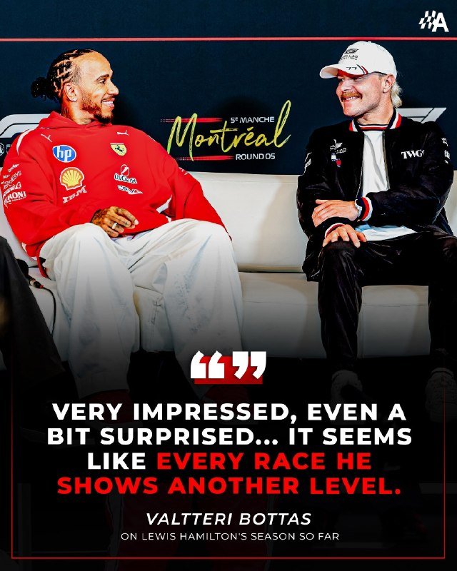 A man in a red Ferrari hoodie and a man in a black Mercedes jacket sit smiling on a white couch during a Montreal race event.