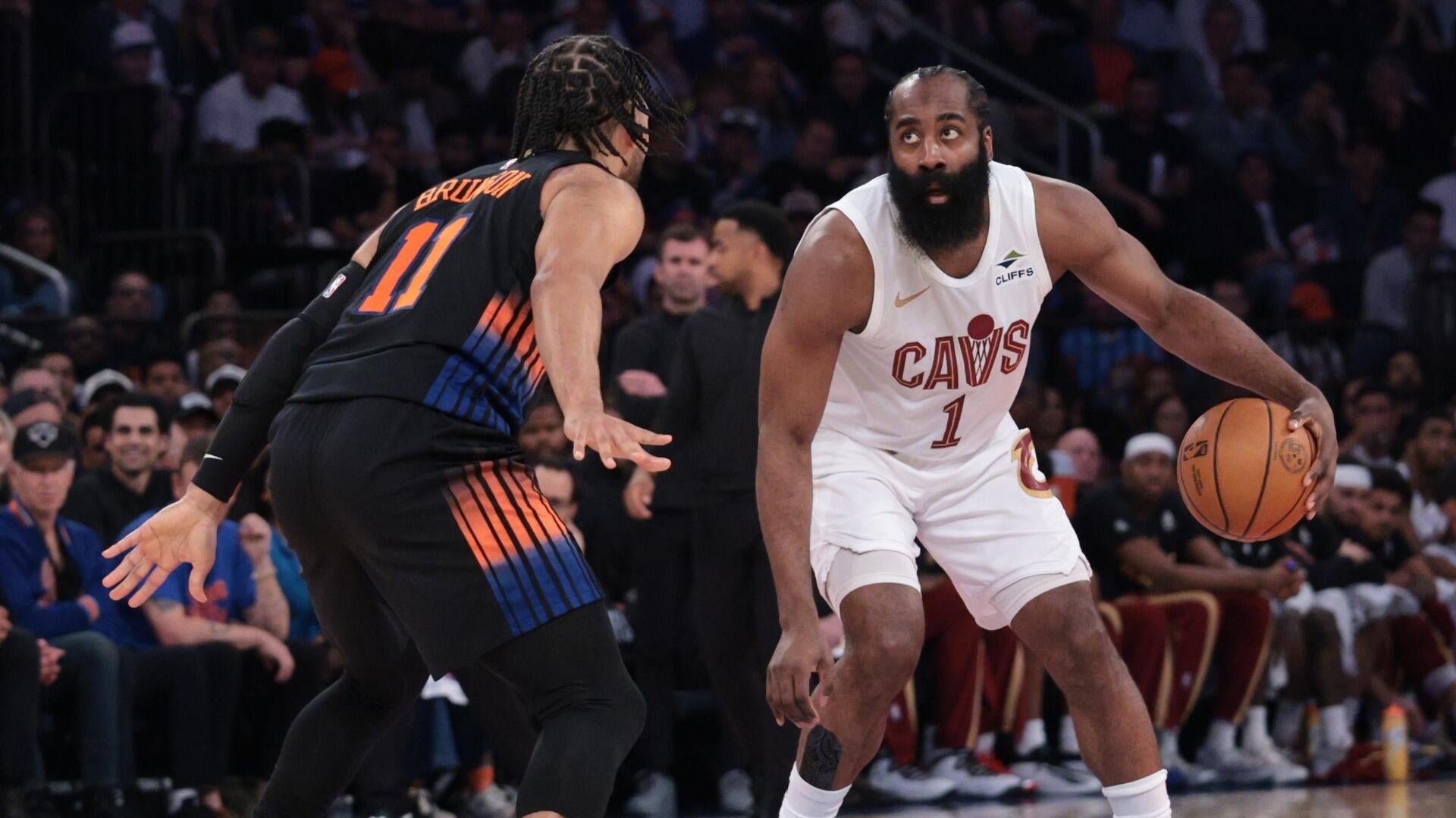 A Cavaliers player wearing jersey number 1 dribbles the basketball while being defended by a Knicks player wearing jersey number 11 during an NBA game.