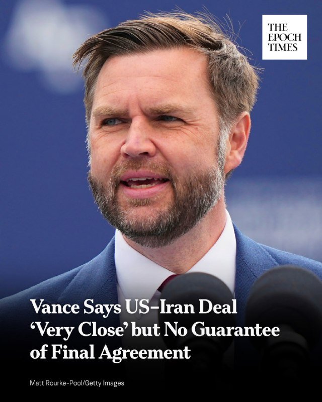 A bearded man in a blue suit speaks at microphones with overlaid text reading "Vance Says US–Iran Deal 'Very Close' but No Guarantee of Final Agreement."