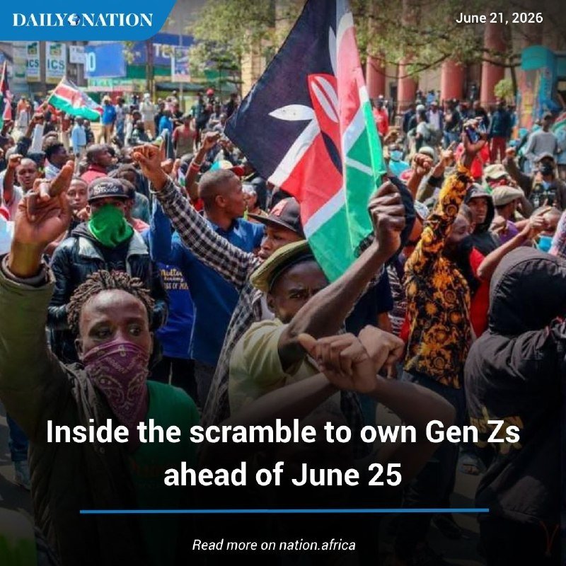 A masked protester waves a Kenyan flag amid a dense crowd with raised fists during a street demonstration.