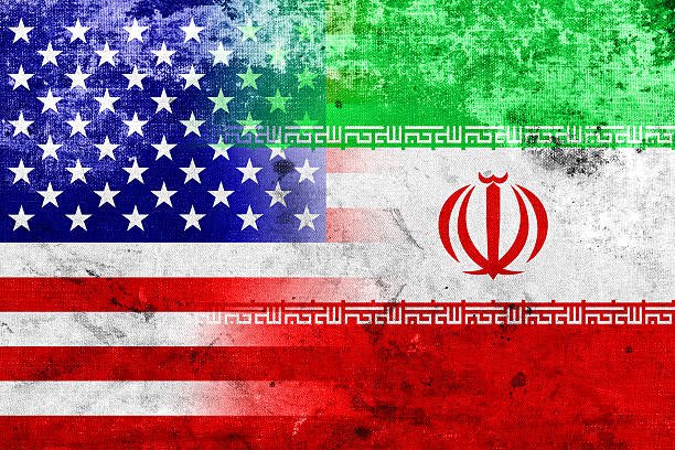 A distressed graphic illustration displays the United States flag merged with the Iranian flag, their designs overlapping on a textured, weathered background.
