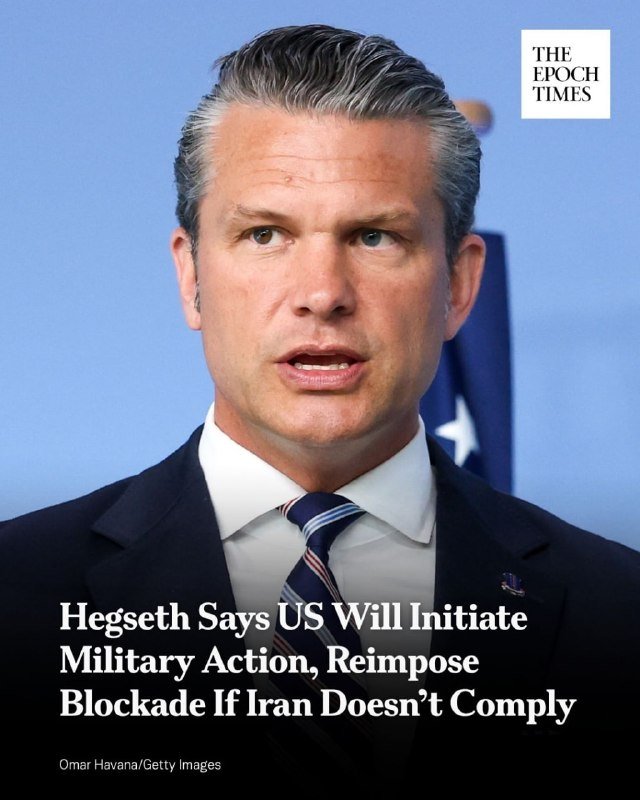 A gray-haired man in a dark suit and striped tie speaks against a blue backdrop with a partially visible American flag, accompanied by an Epoch Times headline about U.S. military action and Iran.