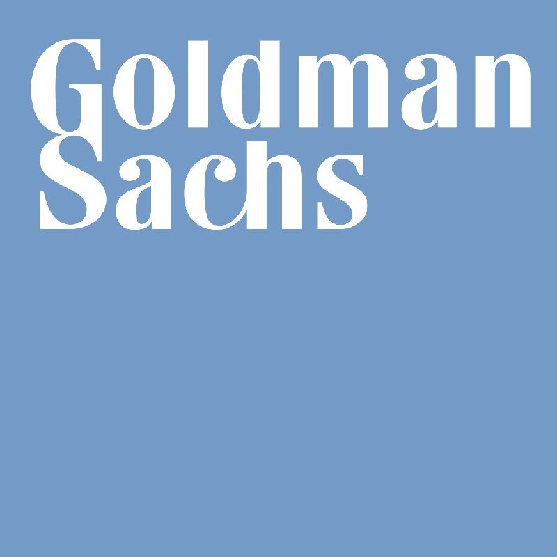The image displays the Goldman Sachs logo, featuring white serif text on a solid light blue background.