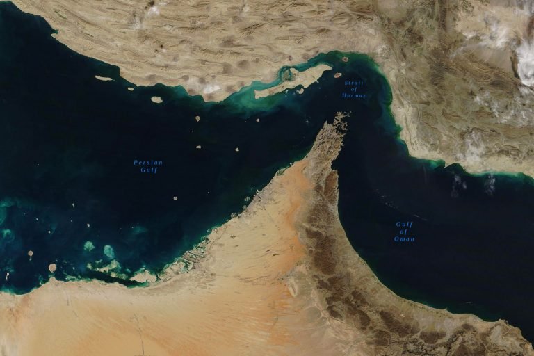 Satellite image showing the Persian Gulf, Strait of Hormuz, and Gulf of Oman, with labeled water bodies bordering arid landmasses.