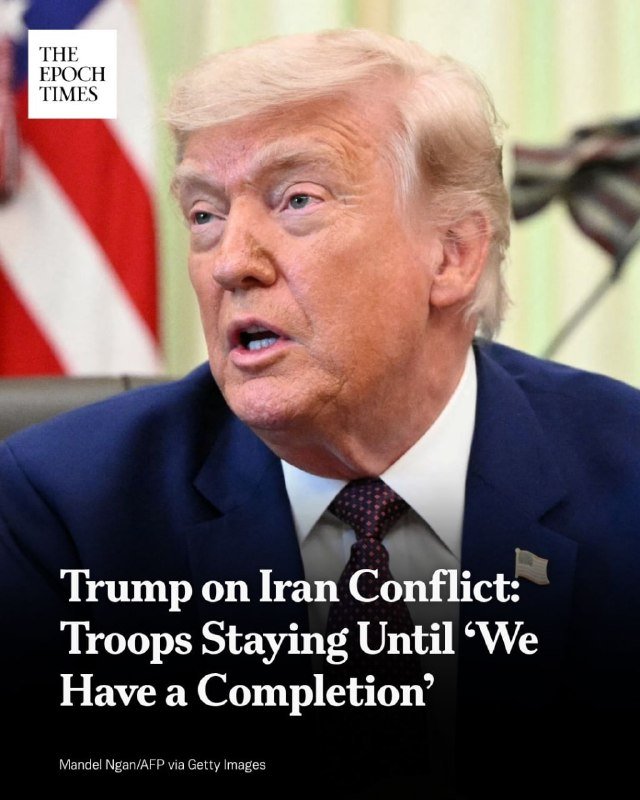A blonde-haired man in a dark suit and patterned tie speaks with an American flag visible behind him; "THE EPOCH TIMES" logo and headline text overlay the image.