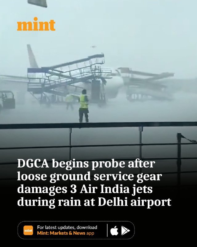 Passenger boarding stairs lie collapsed against aircraft in heavy rain on a foggy tarmac, with a worker in a high-visibility vest standing nearby.