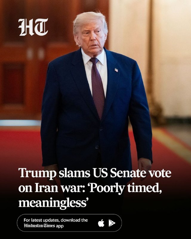 A man in a dark blue suit and red tie stands on a red carpet with text reading "Trump slams US Senate vote on Iran war: 'Poorly timed, meaningless'" alongside an "HT" logo.