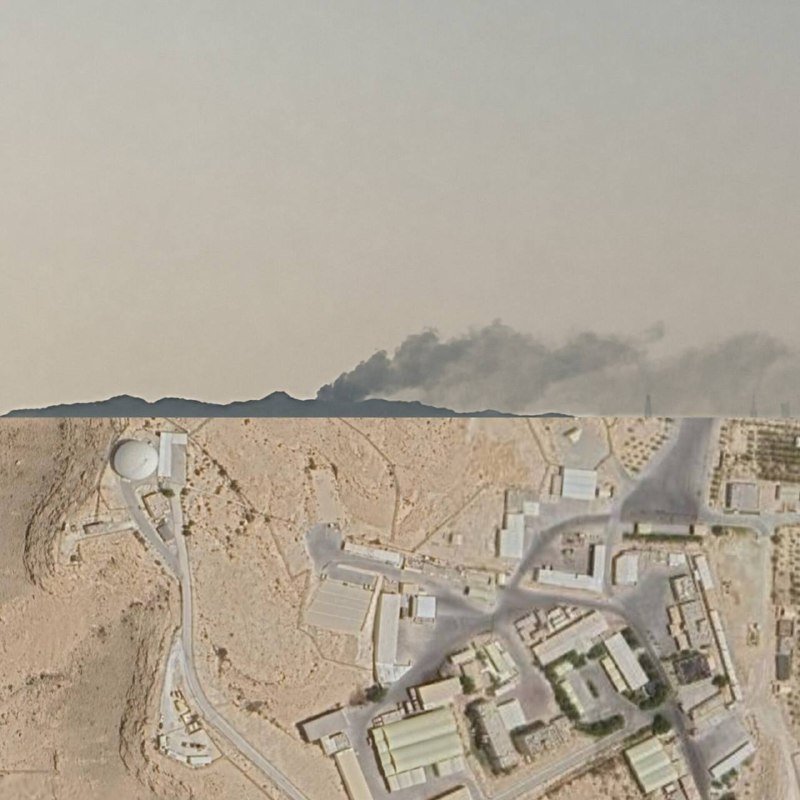 A split image shows dark smoke rising above a desert ridge in the upper portion, while the lower portion displays an aerial view of a desert compound with buildings, roads, and storage tanks.