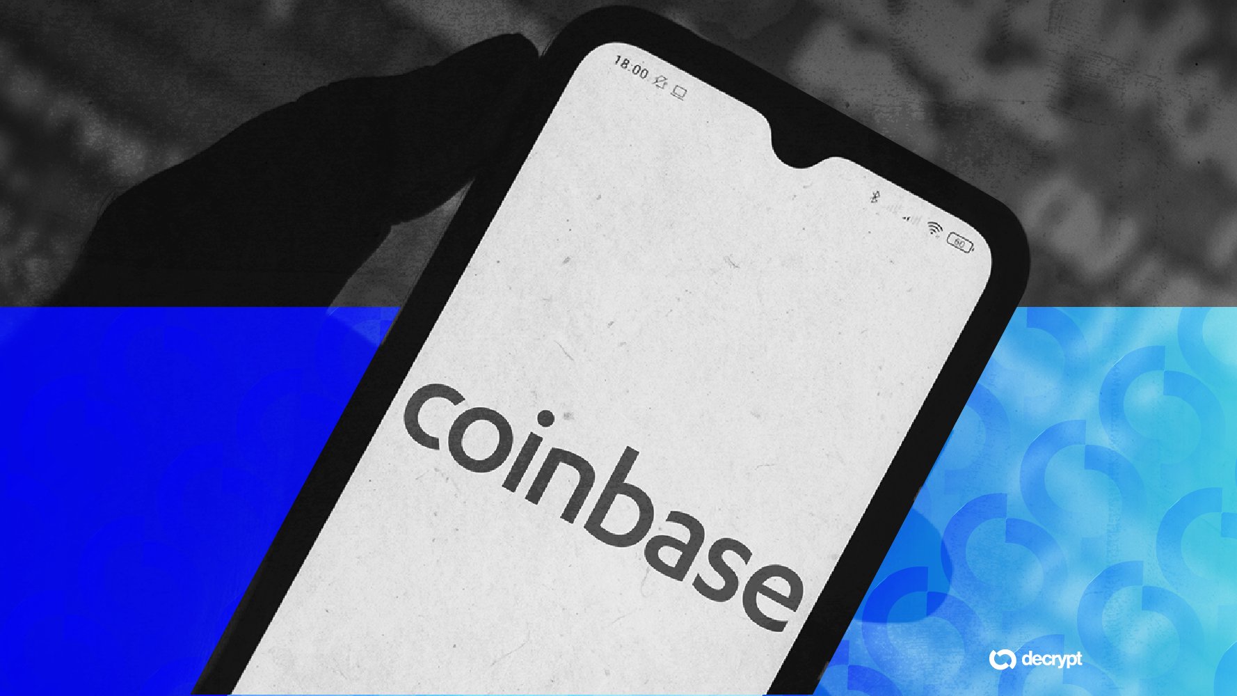 A silhouetted hand holds a smartphone displaying the Coinbase logo, shown against a split blue background with a "decrypt" watermark.