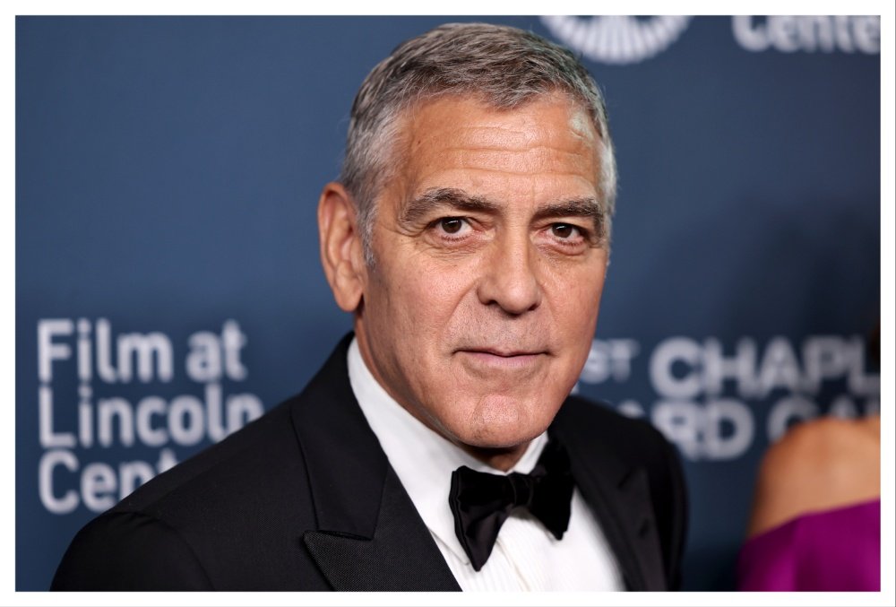 A gray-haired man in a black tuxedo and bow tie poses in front of a blue backdrop reading "Film at Lincoln Center" and "Chaplin."