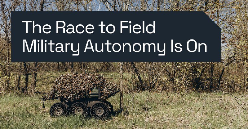 A camouflaged six-wheeled unmanned ground vehicle sits in a wooded field beneath a banner reading "The Race to Field Military Autonomy Is On."