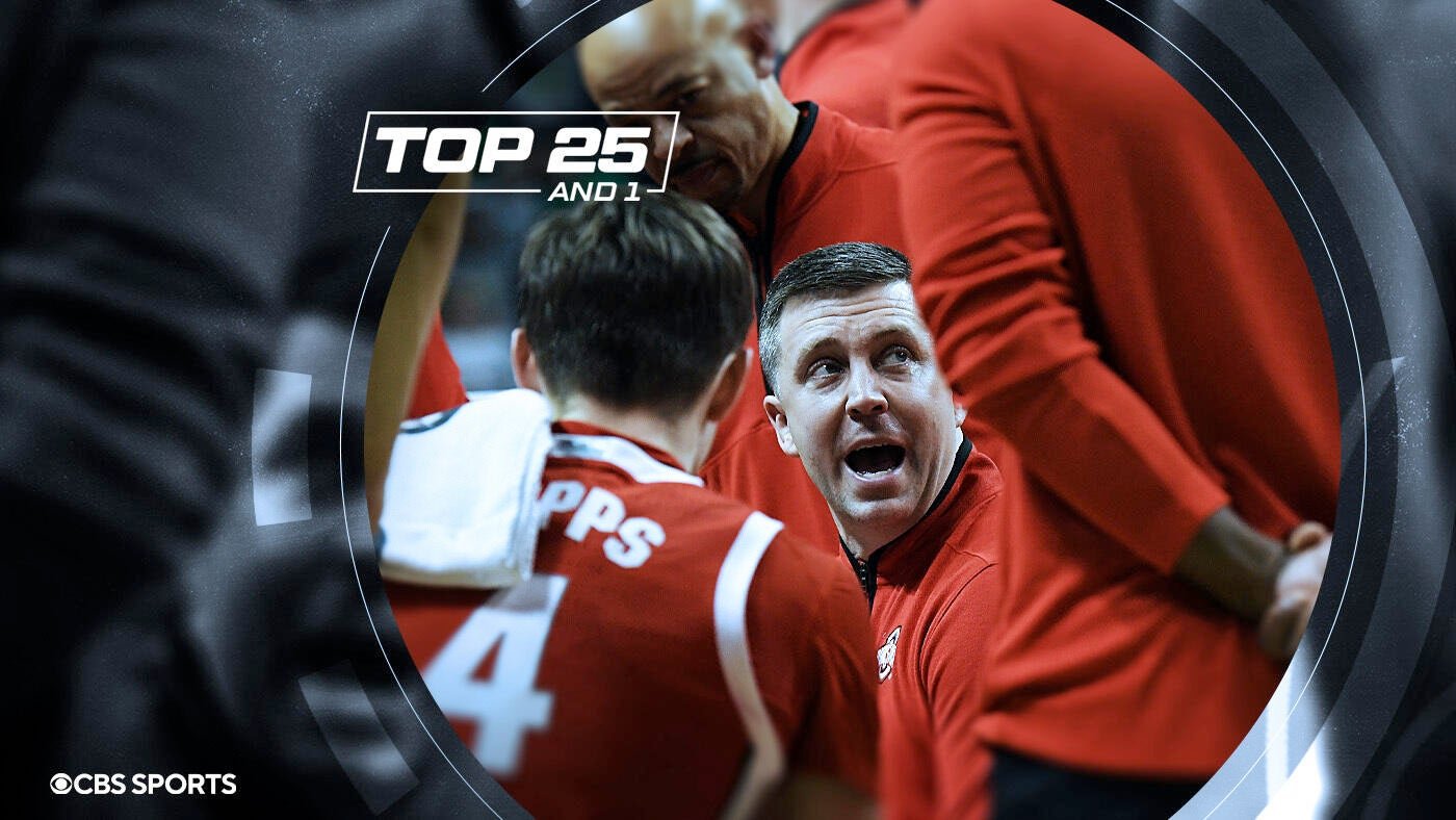 A CBS Sports "Top 25 and 1" graphic shows a coach in a red pullover speaking to a player in a red jersey with a towel over his shoulder.
