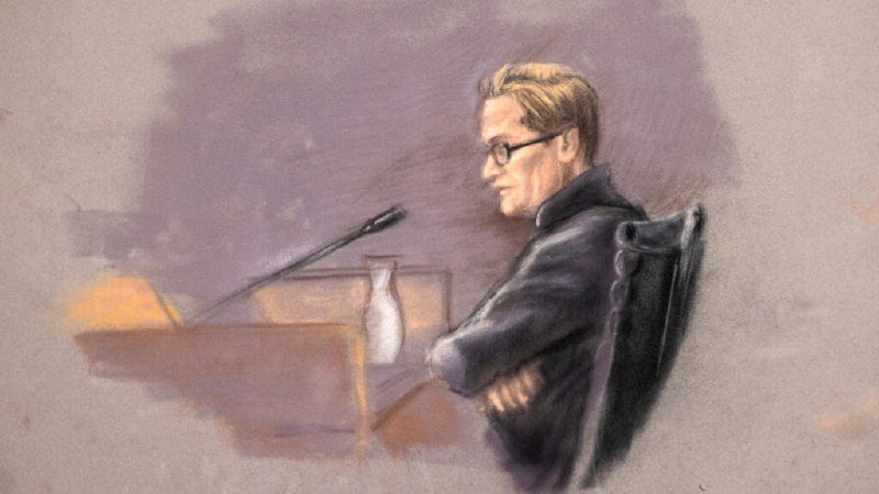 A courtroom sketch depicts a blonde, bespectacled man in a dark jacket seated beside a microphone and a water pitcher against a purple-toned background.