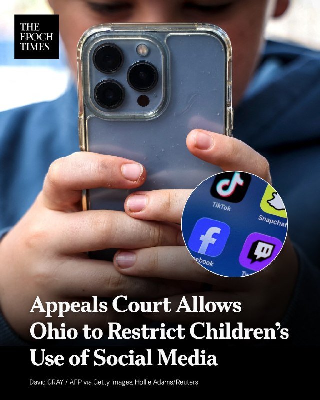 A person holds a smartphone displaying social media app icons, including TikTok, Snapchat, Facebook, and Twitch.