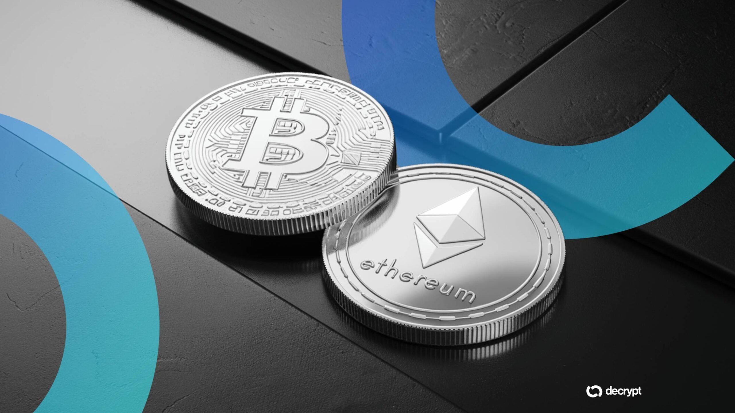 Silver Bitcoin and Ethereum coins rest on a dark surface against a blue gradient backdrop with a "decrypt" logo in the corner.