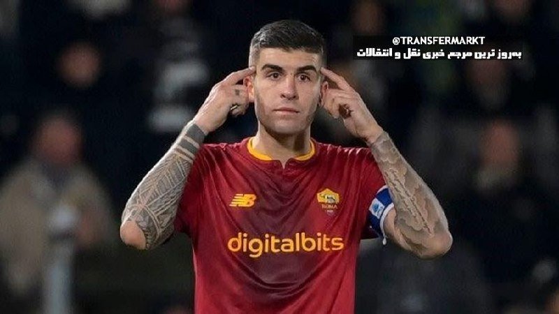 A tattooed soccer player in a maroon Roma jersey with "digitalbits" sponsorship points to his temples with both index fingers.