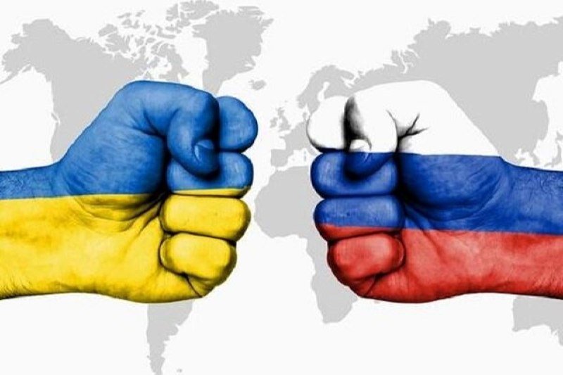 Two clenched fists painted in blue-and-yellow and white-blue-red flag colors face each other against a gray world map background in this illustrated graphic.