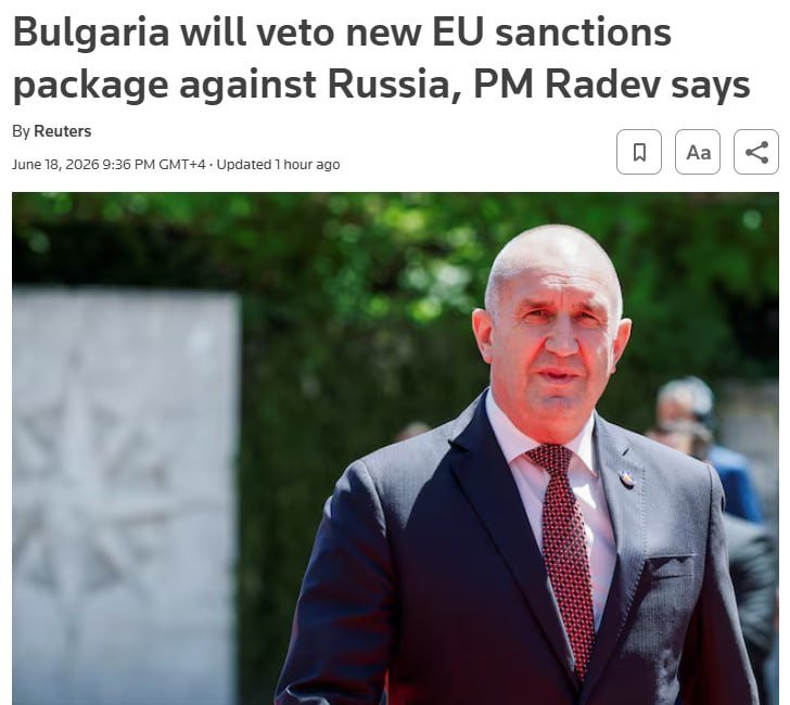 A bald man in a dark suit, white shirt, and red patterned tie stands outdoors with blurred greenery behind him in a Reuters news article screenshot.