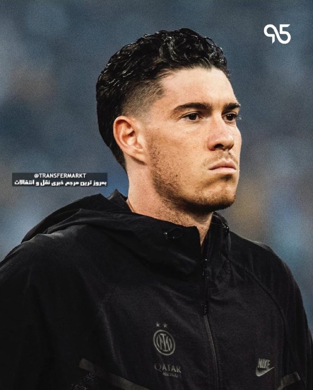 A dark-haired man in a black Paris Saint-Germain tracksuit stands before a blurred stadium crowd, with a "95" logo and social media watermark visible.