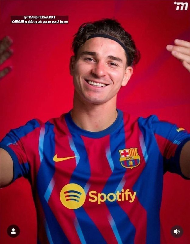A smiling young man wearing a black headband poses in a red and blue striped FC Barcelona jersey with a Spotify sponsor logo against a solid red background.