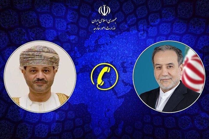 Graphic illustration showing two men's portraits flanking a phone icon, with Persian text and an emblem above, against a blue patterned background.