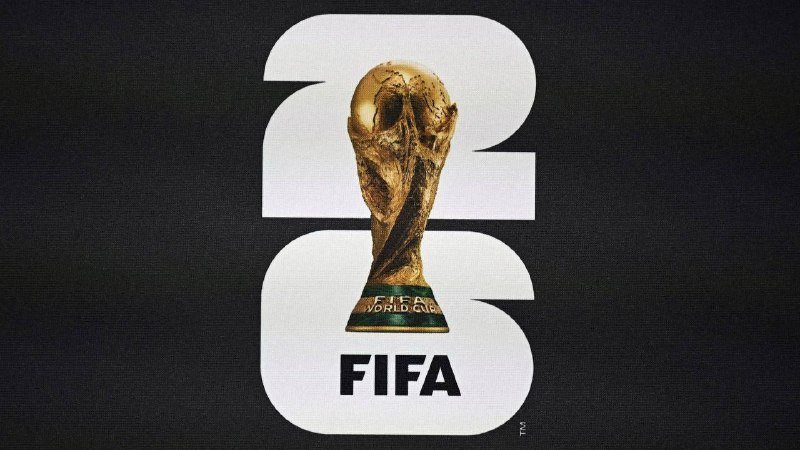 A gold FIFA World Cup trophy is displayed in front of a large white "26" graphic with the word "FIFA" below, set against a dark background.