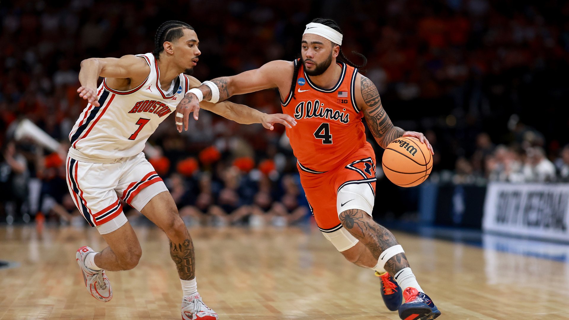 An Illinois player wearing jersey number 4 drives with the basketball while being defended by a Houston player wearing jersey number 7 during a collegiate basketball game.