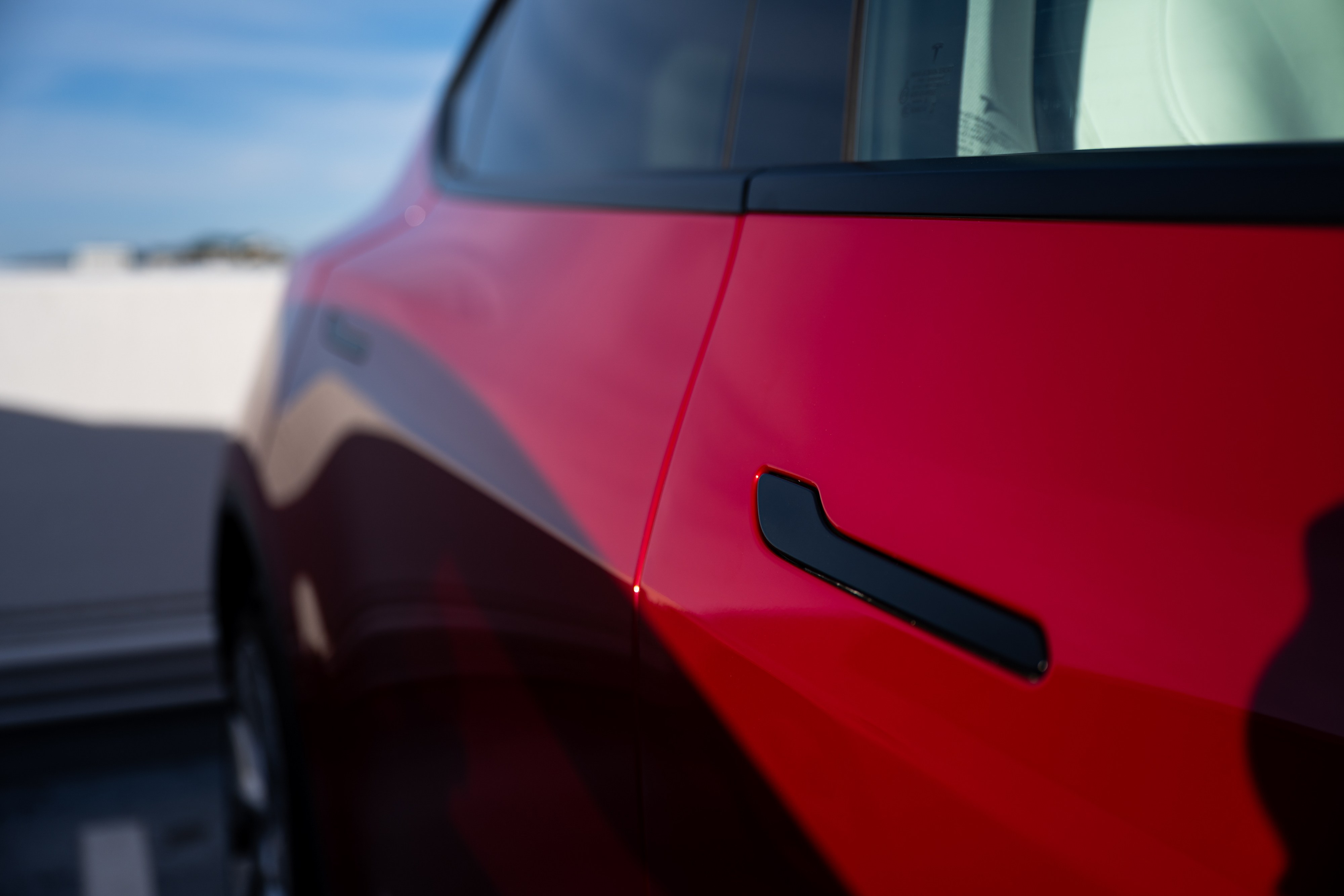 A Model 3 reportedly operating in self-driving mode struck a Texas home and killed a woman, prompting a federal probe — the latest in a string of crashes that exposes how thin the line remains between assisted driving and full autonomy.