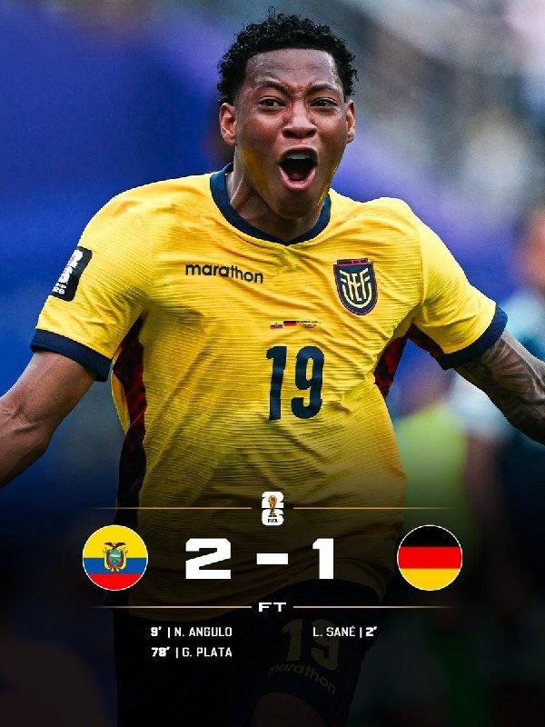 A soccer player in a yellow jersey with "marathon" branding, an Ecuador crest, and number 19 celebrates with an open mouth, displayed above a final score graphic reading "2-1" with Ecuador and Germany flags.